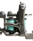 Jonesy-style one-off coil liner tattoo machine handmade by Lucky Supply with mint green wrapped coils, silver frame, and tuned liner setup.