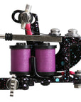 Tattoo machine with purple coils on a white background