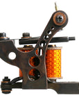 Lucky Supply Drilled Coleman shader tattoo machine with orange coil wraps
