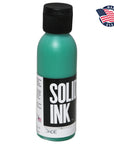 Bottle of Solid Ink jade color with a black cap on a white background