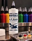Waverly A.P. Black tattoo ink on professional workstation with colored inks and prepared ink caps