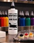 Waverly Dark Black tattoo ink on a professional workstation with colored inks and prepared ink caps