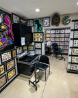 Tattoo studio with tattoo designs on walls and two ways to set up stations