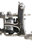 Jonesy-style one-off coil liner tattoo machine handmade by Lucky Supply featuring reflective chrome-style wrapped 1¼” coils, compact silver frame, and tuned liner setup.