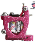 Pink tattoo machine with heart design on a white background, featuring Lucky Mfg branding.