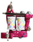 Tattoo machine with colorful heart pattern on a pink background