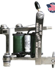 Metallic tattoo machine with green thread, 'Master Brand' branding, and 'Made in USA' label on a white background.