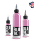 Three bottles of Solid Ink tattoo ink with pink liquid on a white background, featuring an 'Made in USA' logo.
