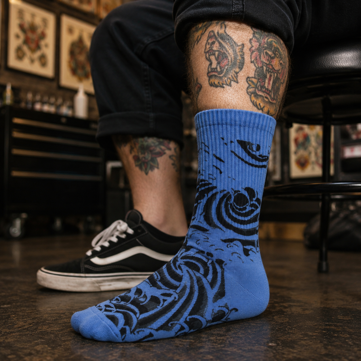 A single crew sock with a dark gray and black abstract wave-like pattern, shown against a plain white background.