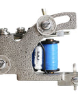 Rollomatic liner tattoo machine with textured nickel frame and coin-style hardware