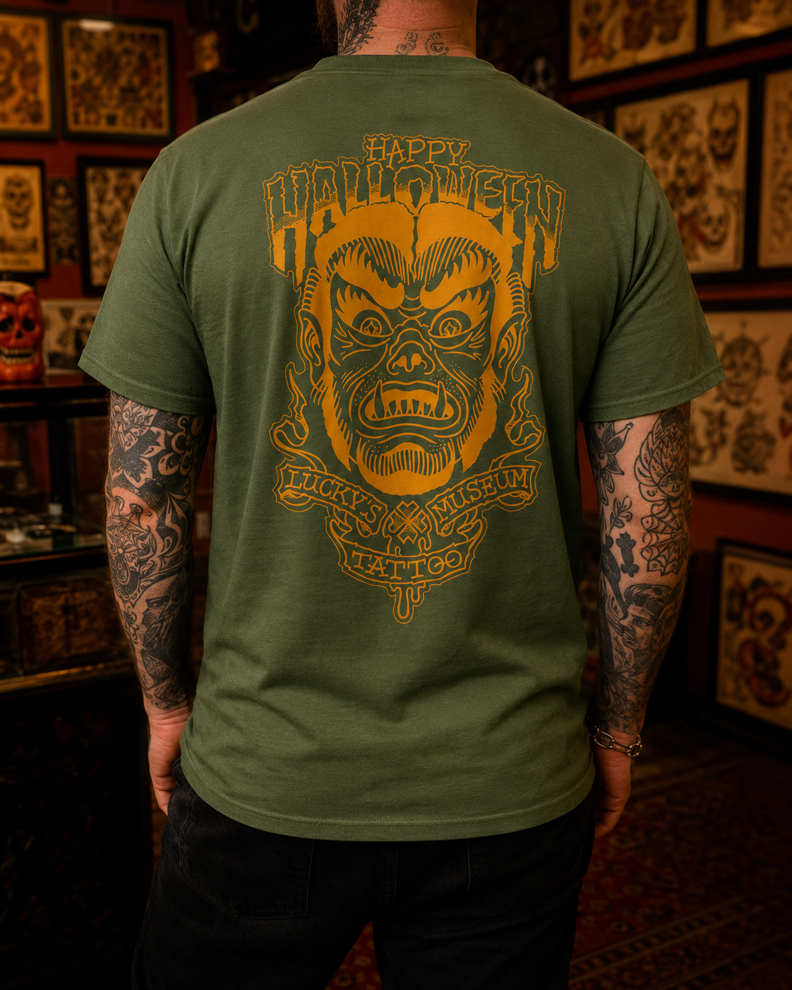 Green t-shirt with a graphic design on the back featuring a face and text.