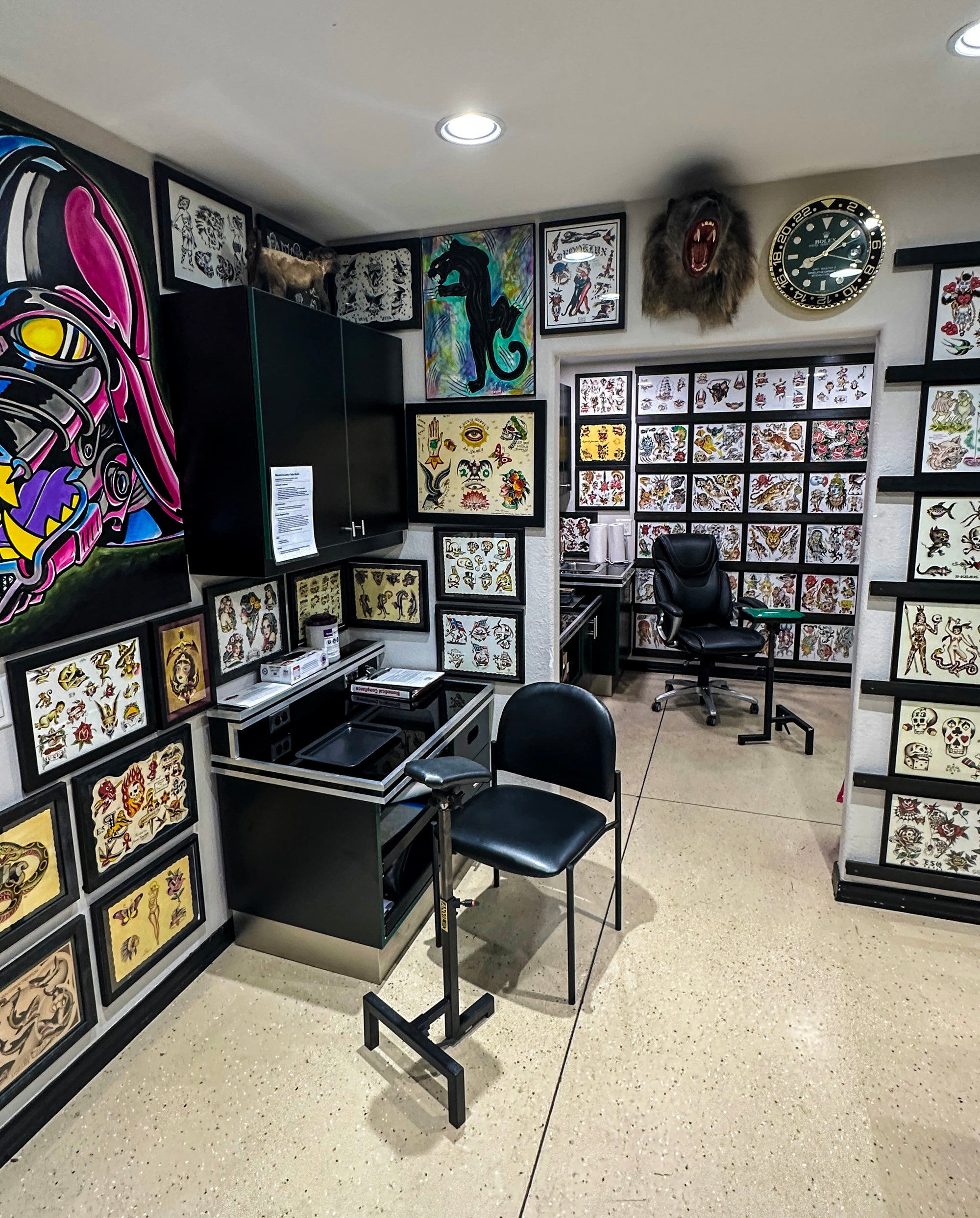 Tattoo studio with tattoo designs on walls and two ways to set up stations