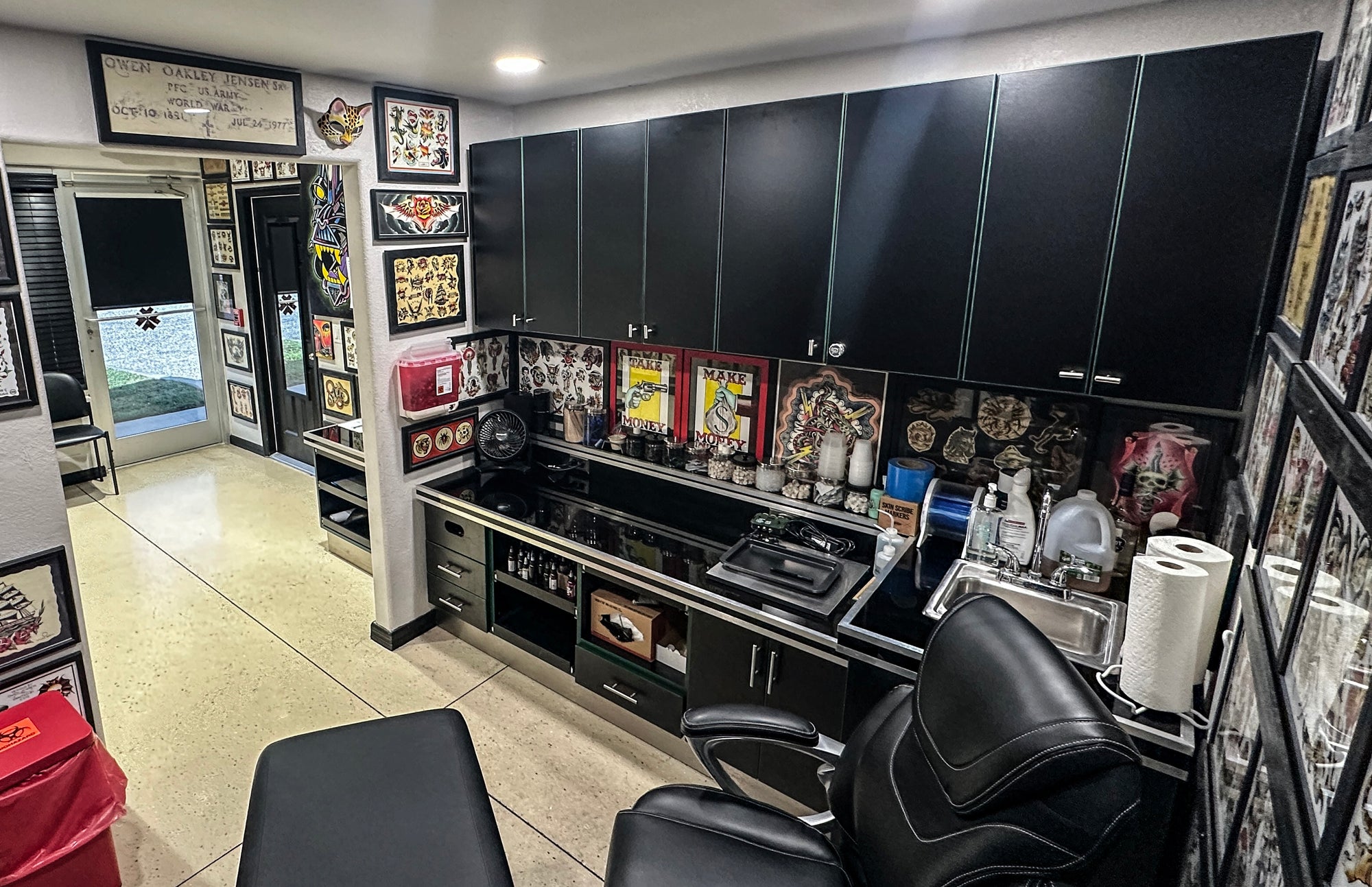 tatoo shop interior with black chairs, counter, and various tattoo supplies